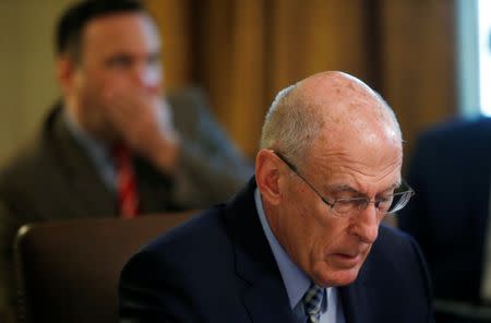 U.S. Director of National Intelligence Dan Coats and White House Social Media Director Dan Scavino (rear) listen during a cabinet meeting at the White House in Washington, U.S., July 18, 2018. REUTERS/Leah Millis