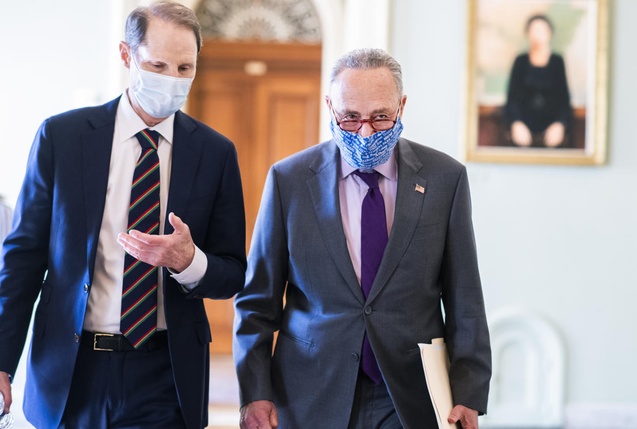 UNITED STATES - SEPTEMBER 30: Senate Minority Leader Chuck Schumer, D-N.Y., right, and Sen. Ron Wyden, D-Ore., make their way to a news conference with Senate Democrats where they addressed topics including the Supreme Court nominee and health care in the Capitol on Wednesday, September 30, 2020. (Photo By Tom Williams/CQ-Roll Call, Inc via Getty Images)