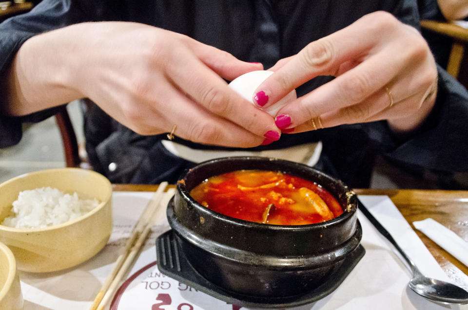 There is great fun to be had in cracking a raw egg into a bubbling cauldron of <em> soondubu</em> (spicy silken tofu stew) at Cho Dang Gol.