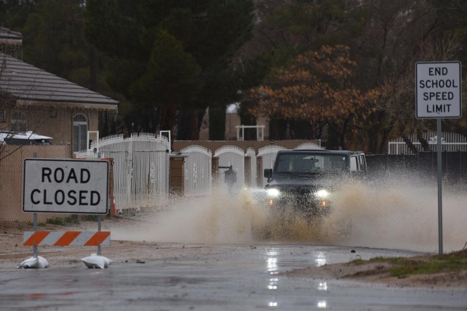 A Jeep crosses a flooded area in Hesperia on Live Oak St. and Datura Rd. on Monday, Feb. 5th, 2024 in Hesperia.