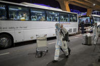 A bus leaves with Chinese tourists from Shanghai, who arrived at Suvarnabhumi airport on special tourist visas, in Bangkok, Thailand, Tuesday, Oct. 20, 2020. Thailand on Tuesday took a modest step toward reviving its coronavirus-battered tourist industry by welcoming 39 visitors who flew in from Shanghai, the first such arrival since normal traveler arrivals were banned almost seven months ago. (AP Photo/Wason Wanichakorn)