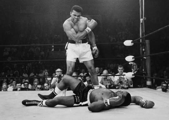 <p>Heavyweight champion Muhammad Ali stands over fallen challenger Sonny Liston, shouting and gesturing shortly after dropping Liston with a short hard right to the jaw on May 25, 1965, in Lewiston, Maine. The bout lasted only one minute into the first round. Ali is the only man ever to win the world heavyweight boxing championship three times. He also won a gold medal in the light-heavyweight division at the 1960 Summer Olympic Games in Rome as a member of the U.S. Olympic boxing team. In 1964 he dropped the name Cassius Clay and adopted the Muslim name Muhammad Ali. (AP Photo/John Rooney)</p>