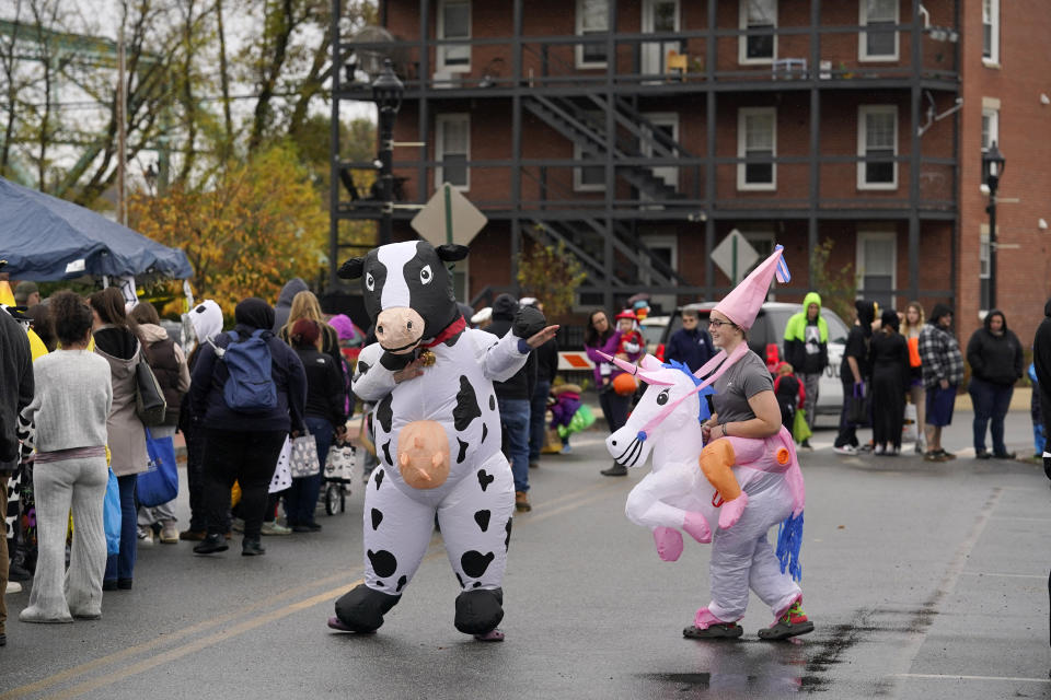 Costumed visitors dance at a halloween event, Sunday, Oct. 29, 2023, in Auburn, Maine. The event helped bring some healing to a community still grieving in the wake of mass shootings that killed 18 people Wednesday night in Lewiston, Maine. (AP Photo/Robert F. Bukaty)