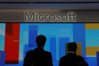 Visitors stand in front of a display screen at Microsoft's new Oxford Circus store ahead of its opening in London