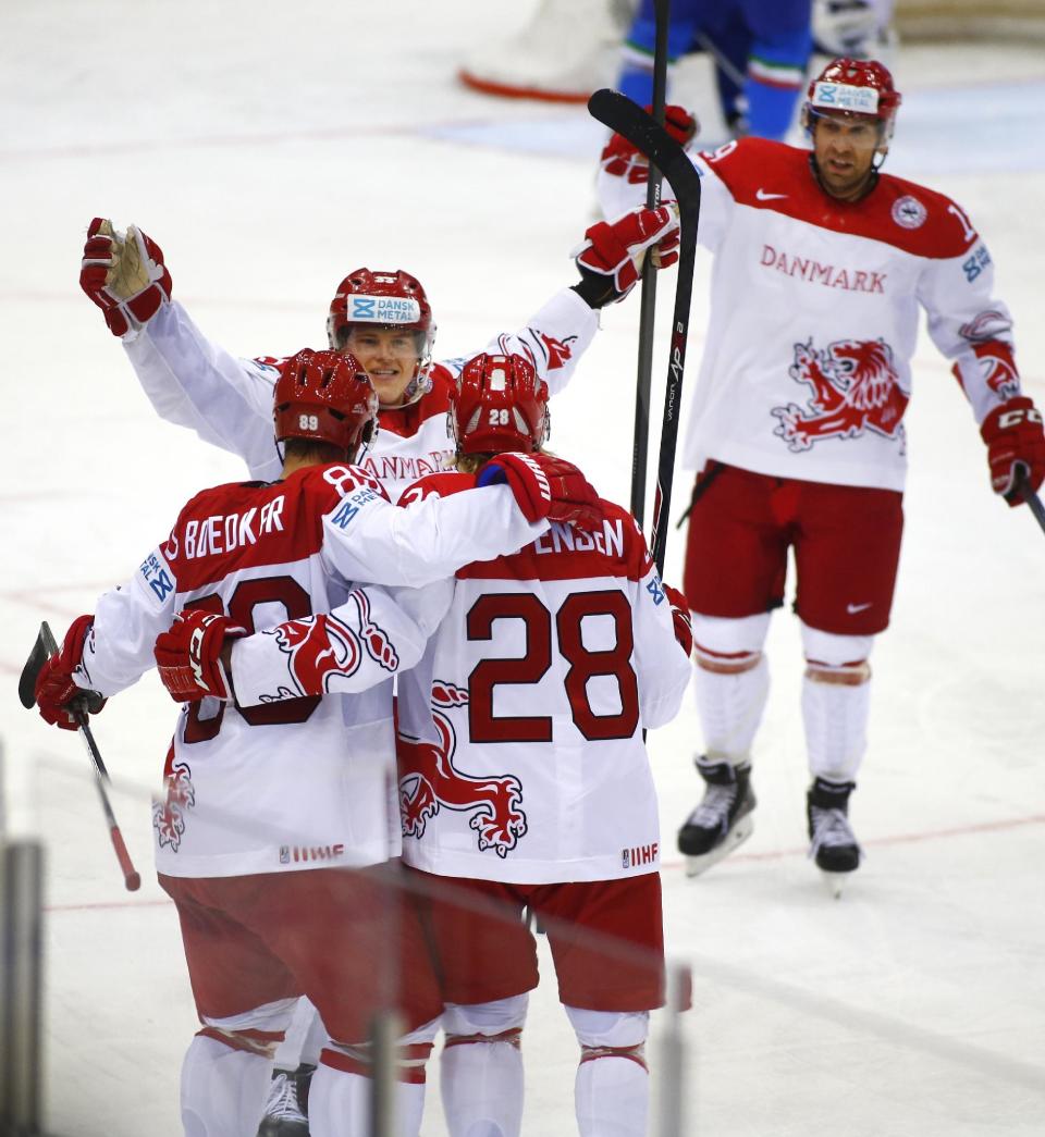 Denmark's players celebrate after Emil Kristensen, foreground right, scored against Italy's during the Group A preliminary round match at the Ice Hockey World Championship in Minsk, Belarus, Tuesday, May 13, 2014. (AP Photo/Sergei Grits)