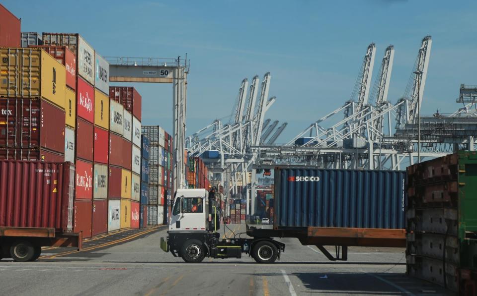 Trucks haul containers through the Georgia Ports Authority Garden City Terminal.