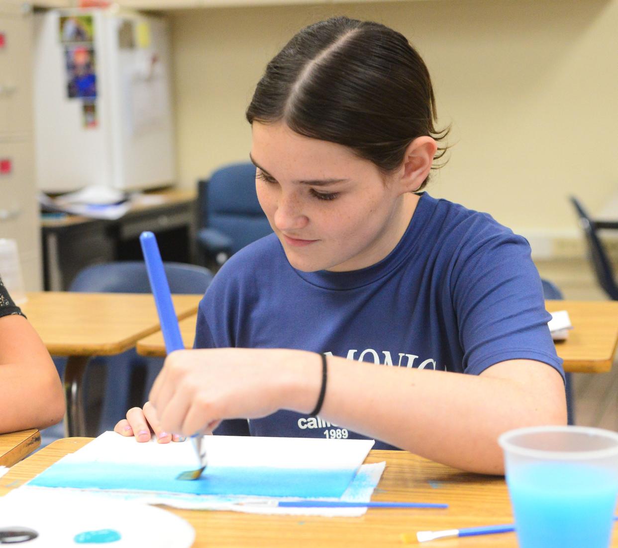 Seventh-grader Carlee Shutler paints a picture after watching the movie "The Dolphins Tale." on the first day of schol at Sebring McKinley Jr./Sr. High School.