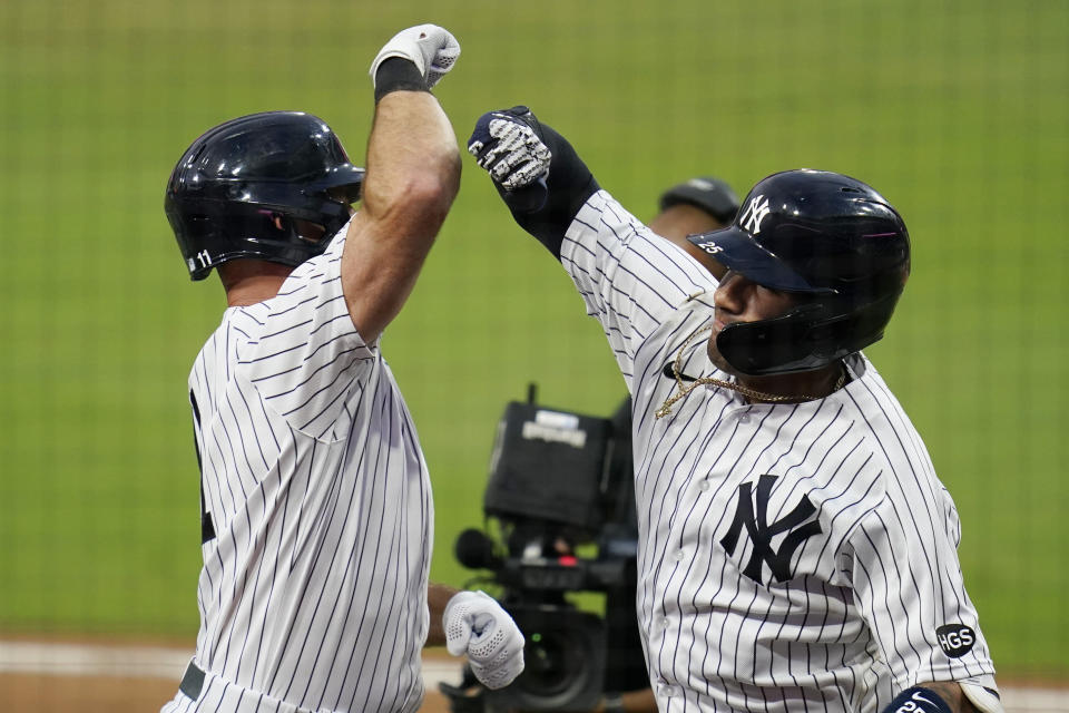 New York Yankees' Gleyber Torres, right, celebrates with Brett Gardner, left, after Torres hit a two-run home run in Game 4 of the ALDS. (AP Photo/Gregory Bull)