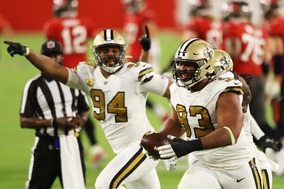 David Onyemata (93) of the New Orleans Saints celebrates with teammates after intercepting a pass during the second quarter against the Tampa Bay Buccaneers. (Photo by Mike Ehrmann/Getty Images)