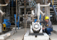 An employee checks facilities at refinery plants of Chambroad Petrochemicals, in Boxing, Shandong Province, China, May 10, 2016. REUTERS/Meng Meng