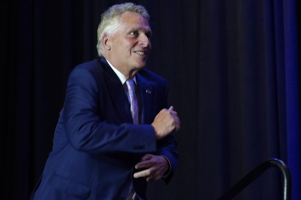 Winner of the Virginia Democratic gubernatorial primary, former Virginia Gov. Terry McAuliffe, bounds up to the stage during an election party in McLean, Va., Tuesday, June 8, 2021. McAuliffe faced four other Democrats in Tuesday's primary. (AP Photo/Steve Helber)