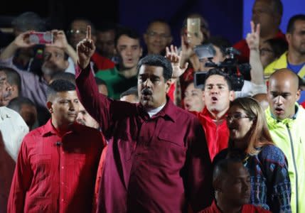 Venezuela's President Nicolas Maduro raises a finger as he is surrounded by supporters while speaking during a gathering after the results of the election were released, outside of the Miraflores Palace in Caracas, Venezuela, May 20, 2018. REUTERS/Carlos Garcia Rawlins