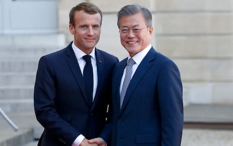 French President Emmanuel Macron welcomes South Korean President Moon Jae-in prior to their meeting at the Elysee Presidential palace this week  - Credit: Getty