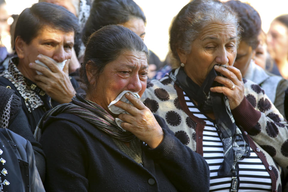 Relatives of 7-year-old Aysu Isgandarova, who died during shelling multiple rocket system shelling by Armenian forces, mourn during a funeral in Garayusifli, Azerbaijan, Wednesday, Oct. 28, 2020. The Azerbaijani Defense Ministry rejected all the accusations and in turn accused Armenian forces of using the Smerch multiple rocket system to fire at the Azerbaijani towns of Terter and Barda. The strike on Barda region killed more than 20 people and wounded 60, Azerbaijani officials said. (AP Photo/Aziz Karimov)