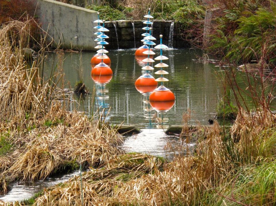 In this Feb. 11, 2013 photo, art complements science on this settlement pond in Seattle's Northgate neighborhood. Sediment ponds slow the flow of storm water, allowing particles and pollutants to settle out. The accumulations are removed every five years or so by Seattle Public Utilities crews, leaving cleaner and clearer water to flow downstream. (AP Photo/Dean Fosdick)