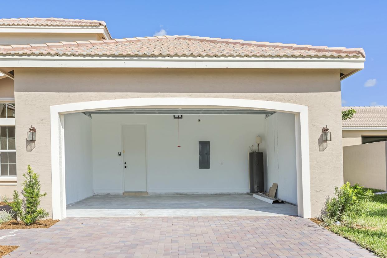 brand new house being built with an empty garage