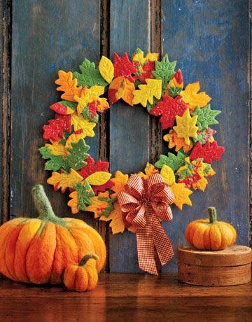 wreath made of fall colored leaf cookies and felt pumpkins