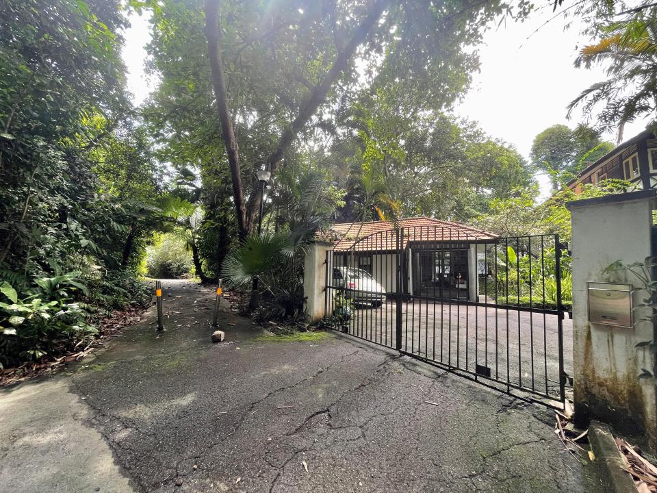 The bungalow sits at the end of a driveway on Mount Faber, a hill located in the southern region of Singapore. However, there is a public path right next to the house where people can hike up to the top of the hill