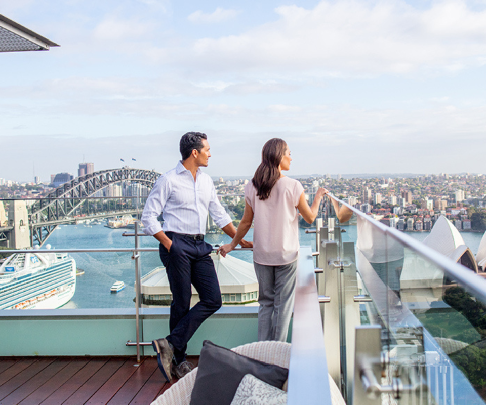 Couple on rooftop overlooking Sydney Harbour