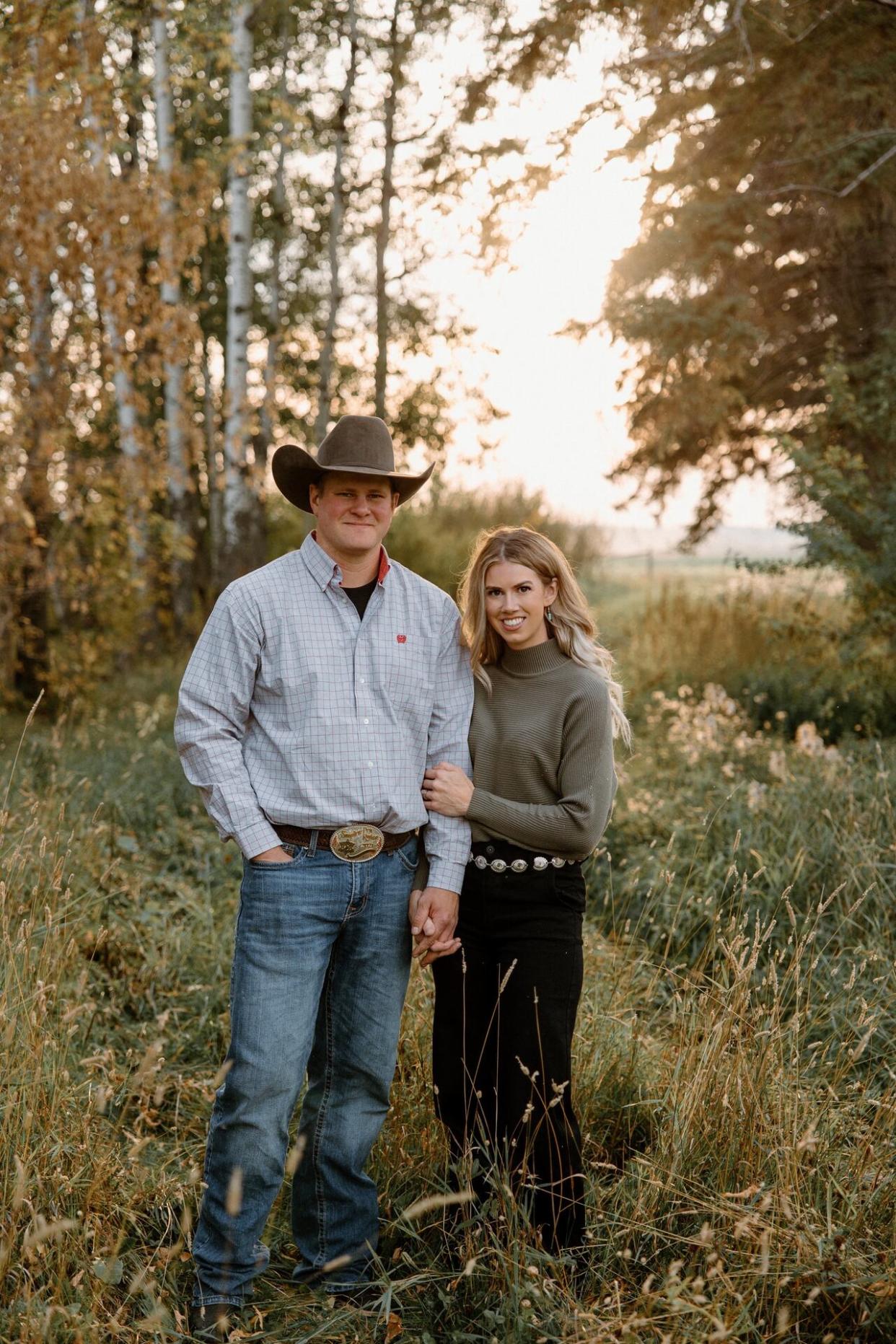 Taylor Dublanko stands with her husband. Dublanko is struggling to find childcare for her kids and may lose her contract if she can't get daycare in time.  (Submitted by Taylor Dublanko - image credit)