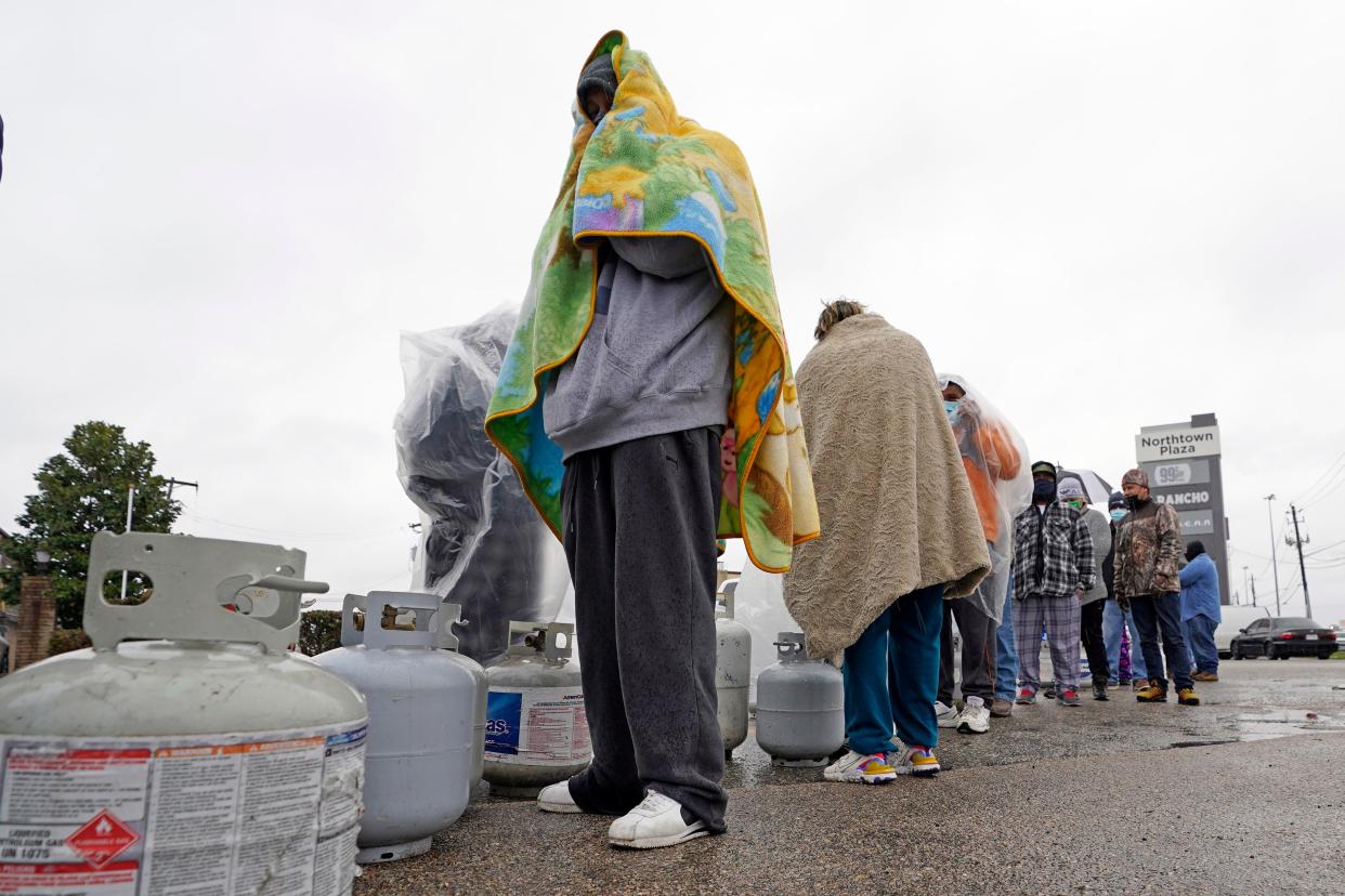 <p>Customers queue up for over an hour in the freezing rain to fill their tanks n 17 February. </p> (AP)