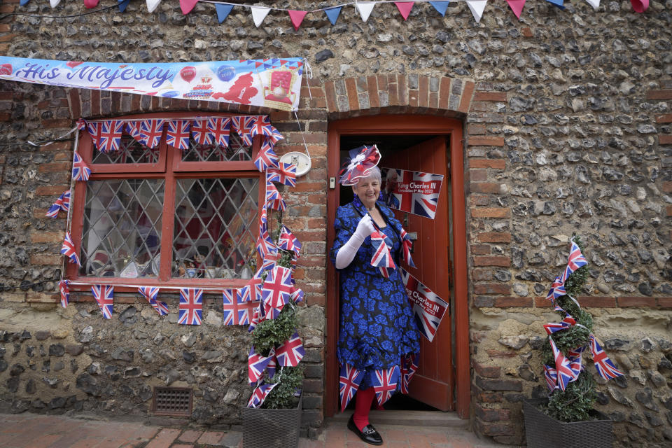 Sylvia Daw leaves her cottage to attend the Big Lunch celebration in Alfriston in East Sussex, England, Sunday, May 7, 2023. The Big Lunch is part of the weekend of celebrations for the Coronation of King Charles III. (AP Photo/Kirsty Wigglesworth)