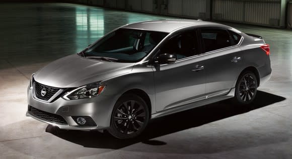 A silver Nissan Sentra compact sedan in a dimly-lit garage, viewed from above.