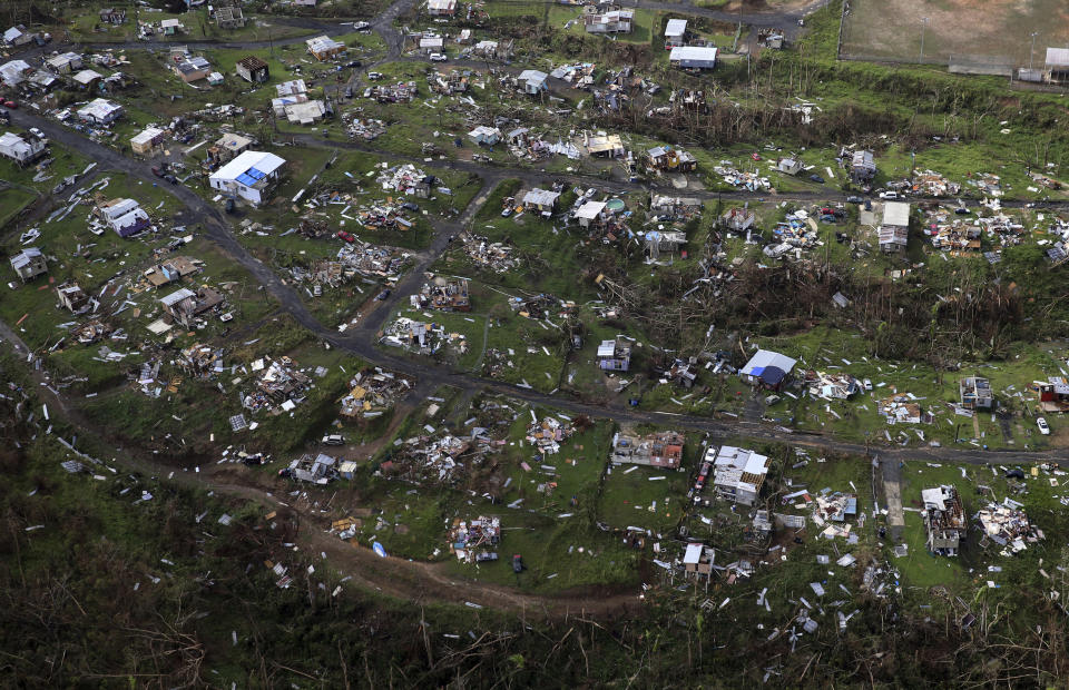 FILE - In this Sept. 28, 2017, file photo, homes and other buildings destroyed by Hurricane Maria lie in ruins in Toa Alta, Puerto Rico. Top Florida Republicans have been quick to say President Donald Trump is wrong about the death toll in Puerto Rico. (AP Photo/Gerald Herbert, File)