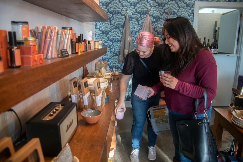 (11/27/21) Jen Immel, left, and Gabri Dominguez shop at the Cena Luna store during the Miracle MIle's Sip and Stroll wine tasting/shopping event in Stockton. CLIFFORD OTO/THE STOCKTON RECORD
