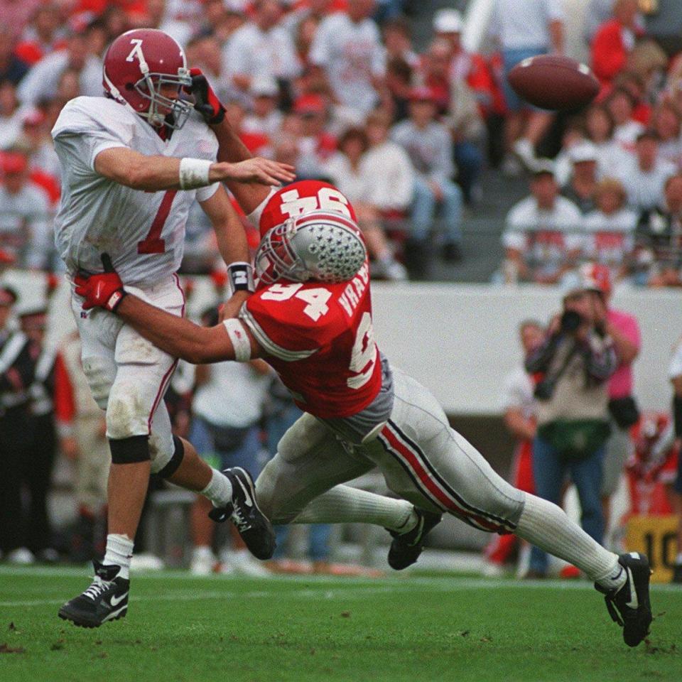 Ohio State’s Mike Vrabel (94) pulls down Crimson Tide quarterback Jay Barker during the OSU-Alabama matchup on Jan. 2, 1995.