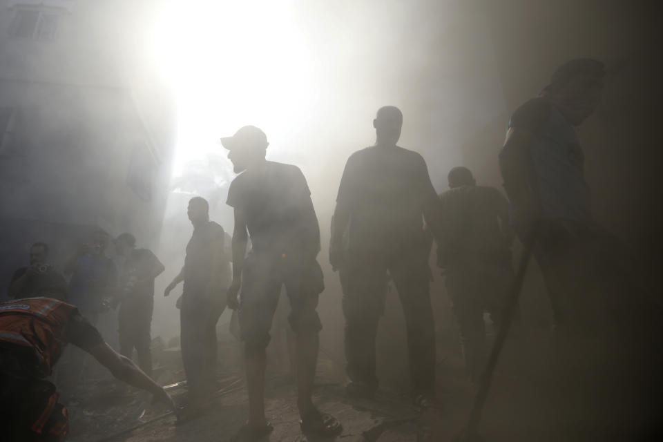 Palestinians look for survivors under the rubble of a destroyed building following an Israeli airstrike in Khan Younis refugee camp, southern Gaza Strip, Monday, Nov. 6, 2023. (AP Photo/Mohammed Dahman)