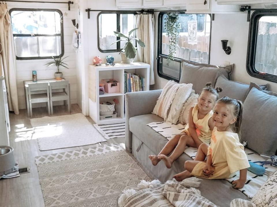 April Gilleland's twins sitting on the couch in the living room of her RV