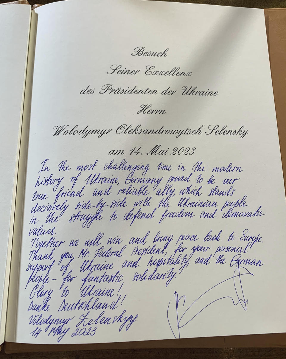 A handwritten note by Ukrainian President Volodymyr Zelenskyy is seen in the visitor's book on the occasion of his meeting with German President Frank-Walter Steinmeier at Bellevue Palace, in Berlin, Sunday, May 14, 2023. Zelenskyy arrived in Berlin early Sunday for talks with German leaders about further arms deliveries to help his country fend off the Russian invasion and rebuild what’s been destroyed by more than a year of devastating conflict. (J'rg Blank/dpa via AP)