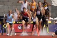 Runners compete during first heat of the men's 3000-meter steeplechase at the U.S. Olympic Track and Field Trials Monday, June 21, 2021, in Eugene, Ore. (AP Photo/Charlie Riedel)