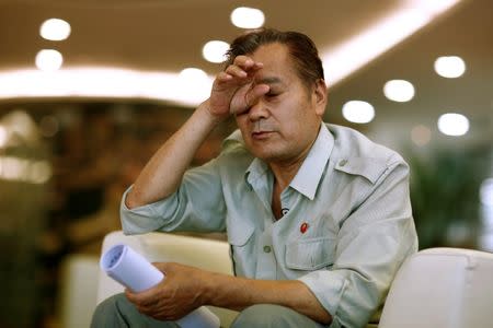 Wang Shiji, founder of the Defend Mao Zedong People's Party, reacts during an interview in Beijing, China, August 21, 2016. Picture taken August 21, 2016. REUTERS/Thomas Peter