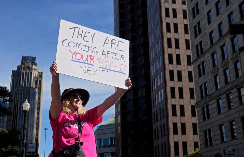 June 24, 2022; Columbus, Ohio, United States; Cindy Krebs, 54, of Columbus, holds a sign at the intersection of Broad and High Streets as hundreds of people rallied at the Ohio Statehouse and marched in support of abortion after the Supreme Court overturned Roe vs. Wade on Friday. Mandatory Credit: Barbara J. Perenic/Columbus Dispatch