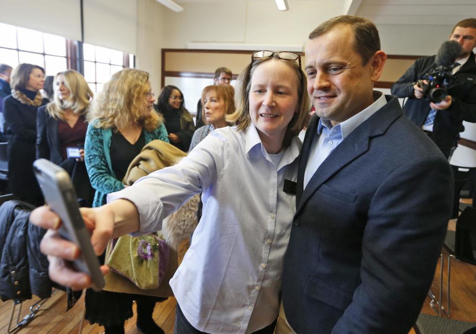 FILE - In this Jan. 5, 2017 file photo, a supporter takes a selfie photo with former Virginia congressman, Tom Perriello, after speaking during a rally in Charlottesville, Va., announcing his candidacy for the Democratic nomination for governor of Virginia. In what sounds like an echo of 2016, governor’s races this year in Virginia and New Jersey are being swept up in many of the same political currents that emerged during last year’s turbulent presidential campaign. (AP Photo/Steve Helber)