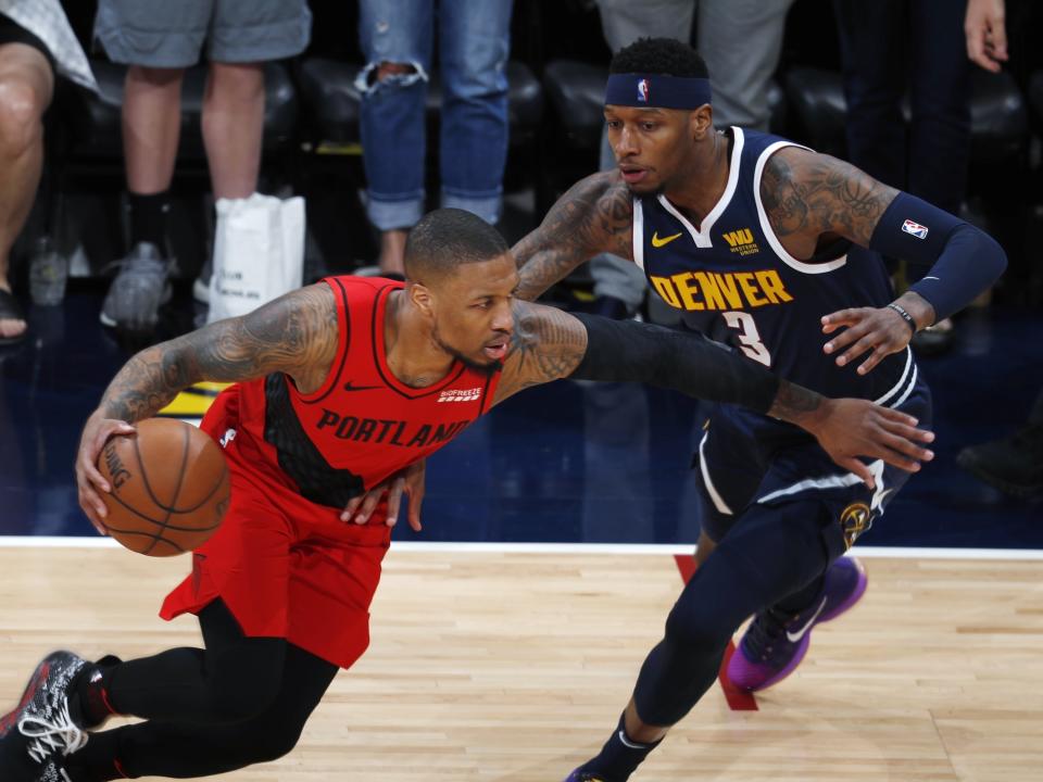 Portland Trail Blazers guard Damian Lillard, left, drives past Denver Nuggets forward Torrey Craig in the first half of Game 7 of an NBA basketball second-round playoff series Sunday, May 12, 2019, in Denver. (AP Photo/David Zalubowski)