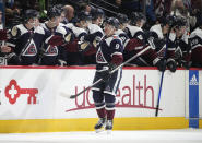 Colorado Avalanche center Evan Rodrigues, front, is congratulated after scoring a goal as he skates by the team bench in the second period of an NHL hockey game against the St. Louis Blues, Saturday, Jan. 28, 2023, in Denver. (AP Photo/David Zalubowski)