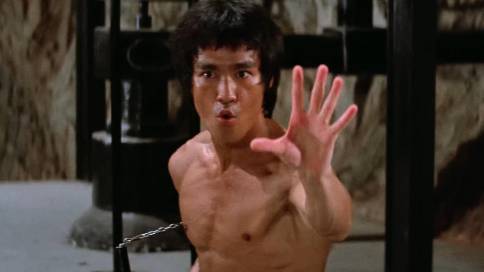 Bruce Lee swings nunchucks in Enter the Dragon