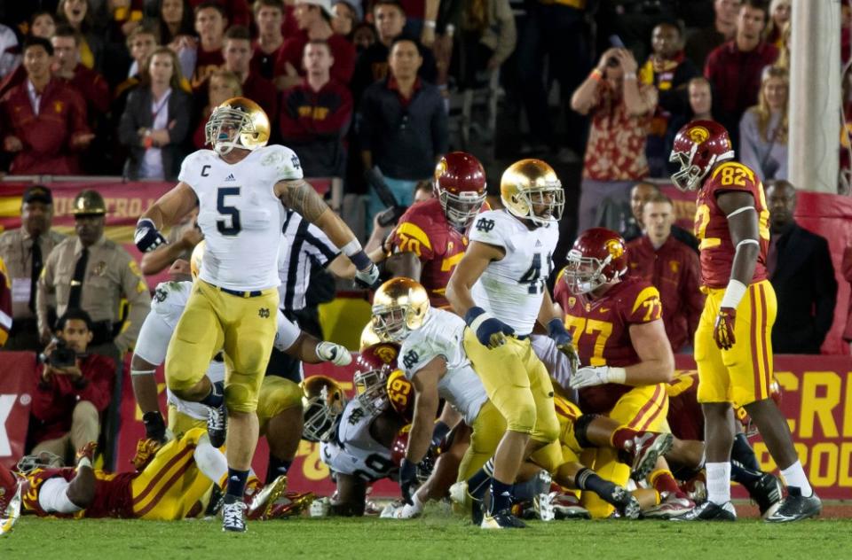 Nov. 24, 2012; Los Angeles, CA, USA; Notre Dame Fighting Irish linebacker Manti Te’o (5) and safety Matthias Farley (41) react after stopping USC Trojans tailback Curtis McNeal (22) near the goal line in the fourth quarter at the Los Angeles Memorial Coliseum. Notre Dame won 22-13. Mandatory Credit: Matt Cashore-USA TODAY Sports