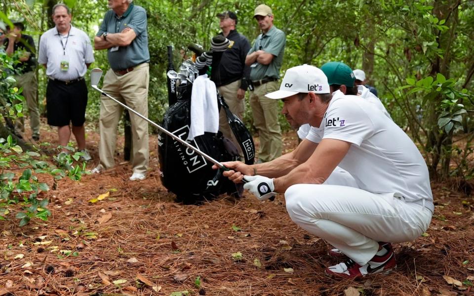 Camilo Villegas, of Colombia, lines up his shot from the pine straw on the second hole during the first round at the Masters golf tournament at Augusta National Golf Club Thursday, April 11, 2024, in Augusta, Ga.