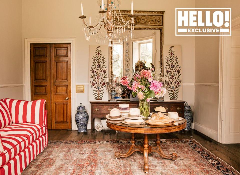 Conran family home living room with round table piled with decorative hats 