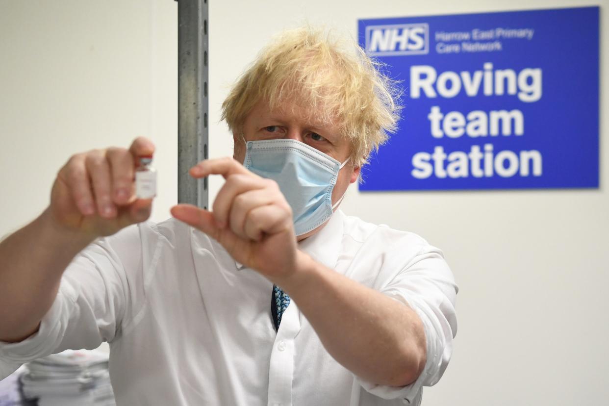 <p>Boris Johnson holds a vial of the Oxford/Astrazeneca vaccine during a visit a north London vaccination centre</p> (Getty Images)