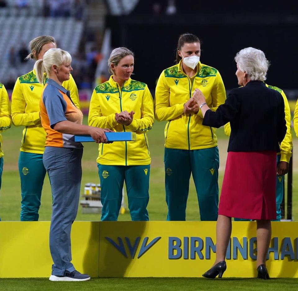 Australia’s Tahlia McGrath receives her medal whilst wearing a mask due to receiving a positive covid-19 test (Adam Davy/PA) (PA Wire)