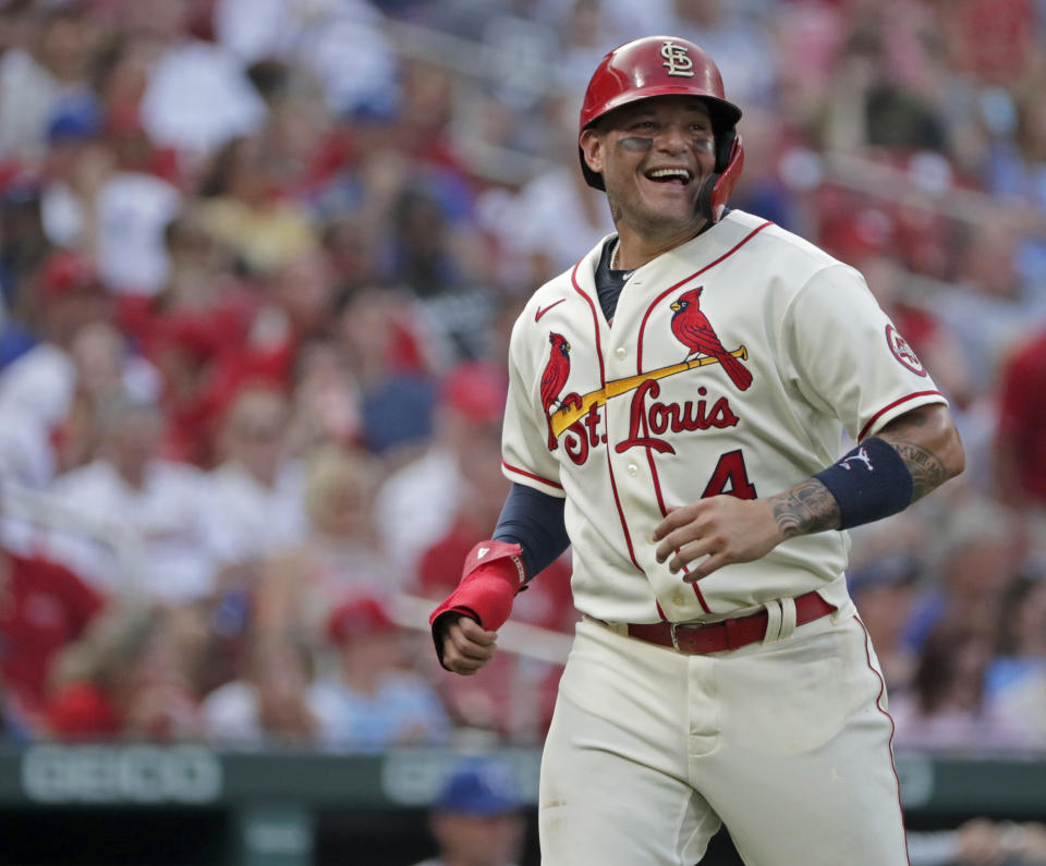 St. Louis Cardinals catcher Yadier Molina smiles while looking toward Kansas City Royals catcher Salvador Perez as Molina heads back to the dugout between the first and second innings of a baseball game Saturday, Aug. 7, 2021, in St. Louis. (AP Photo/Tom Gannam)