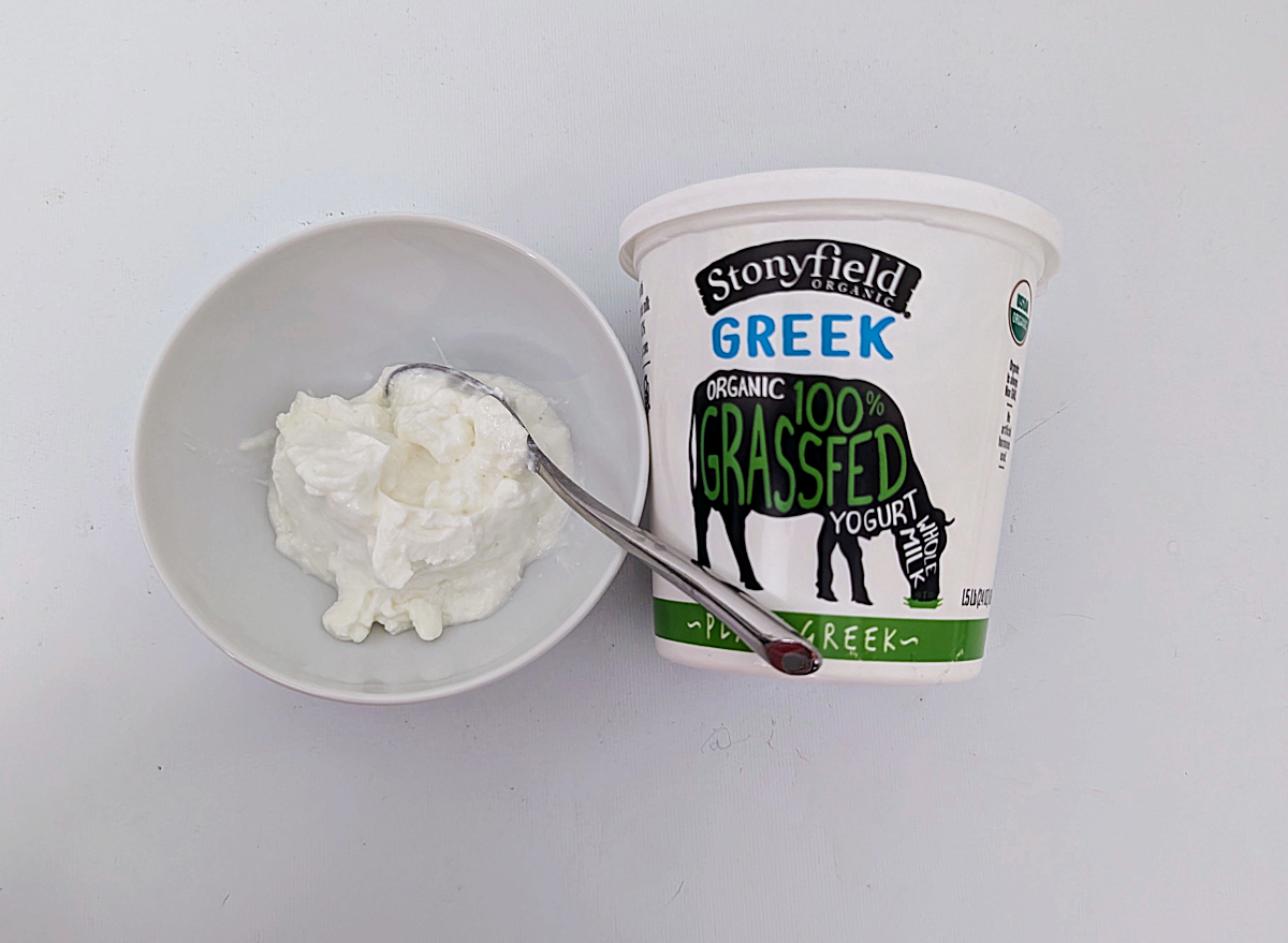 stonyfield greek yogurt in a bowl and a container. 