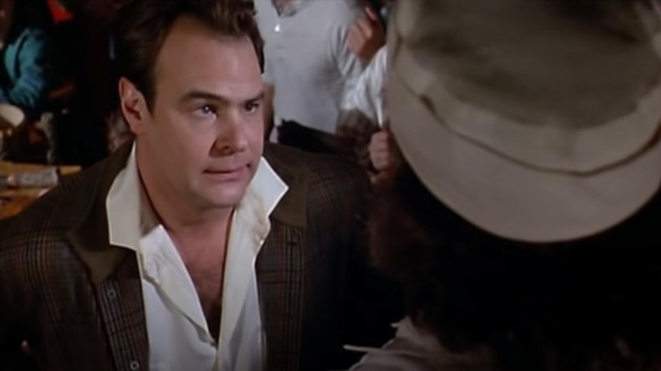 Dan Aykroyd looking up at a chef in The Great Outdoors.