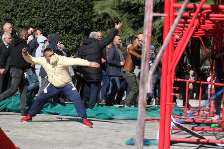 Supporters of the opposition throw stones at the doors of Albanian Prime Minister Edi Rama's office in Tirana, Albania February 16, 2019. REUTERS/Florion Goga