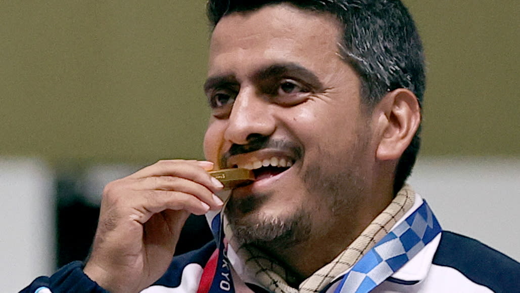 Iran's Javad Foroughi celebrates his gold medal in air pistol, but not everyone is. (Reuters/Ann Wang)